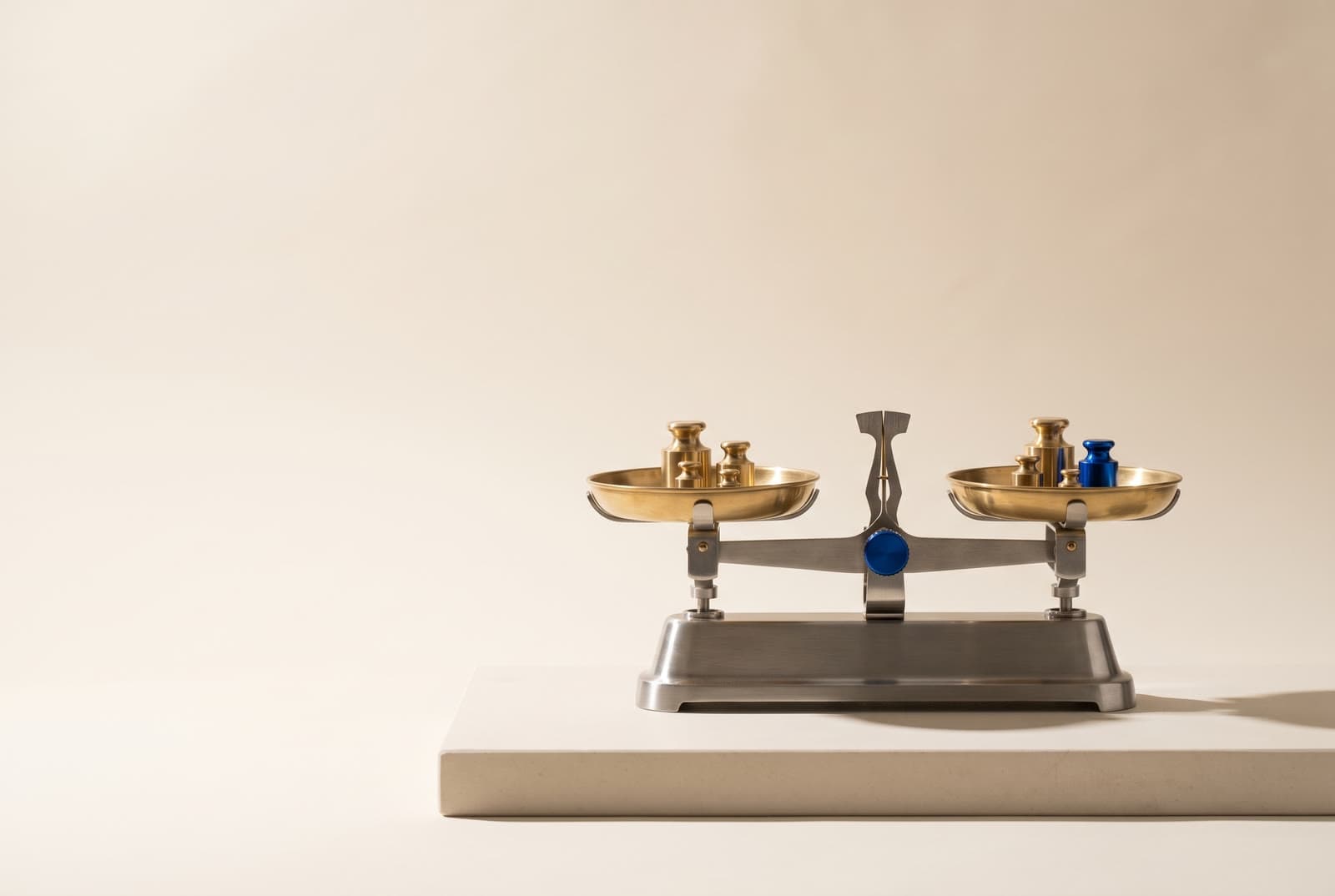 A precision balance scale with brass weights, its beam level